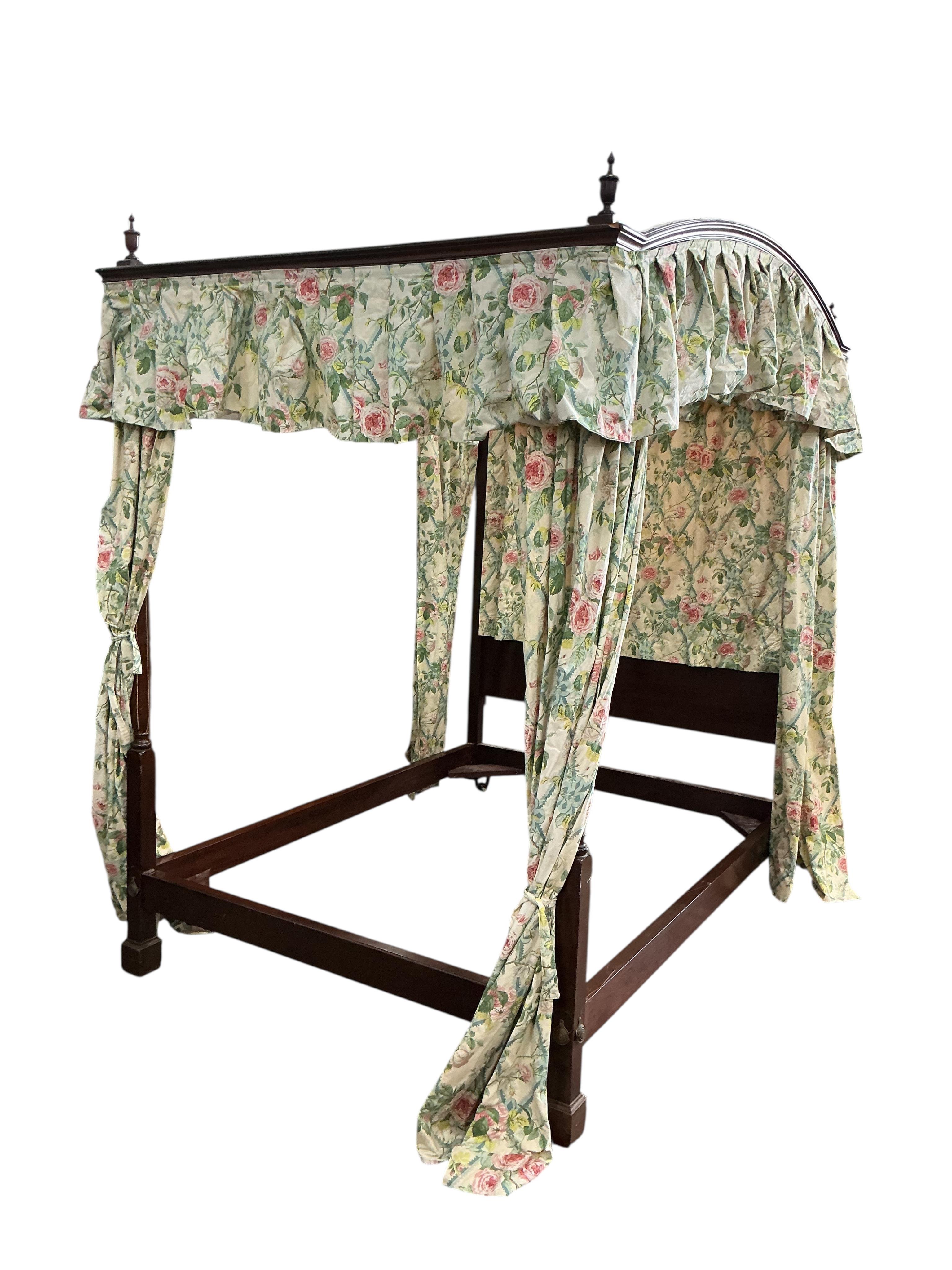 A George III style mahogany four poster bed, with floral drapes, width 150cm, length 208cm, height 220cm